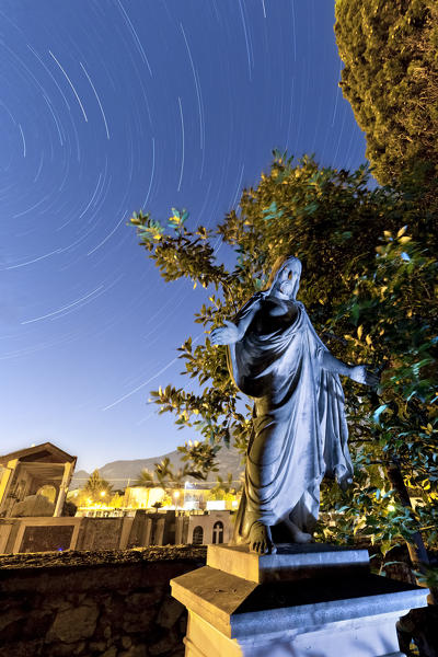 The statue of Jesus Christ at the evangelical cemetery of Arco. Trento province, Trentino Alto-Adige, Italy, Europe.