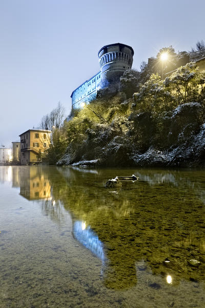 The castle of Rovereto, home of the War Museum, is reflected in the Leno stream. Trento province, Trentino Alto-Adige, Italy, Europe.