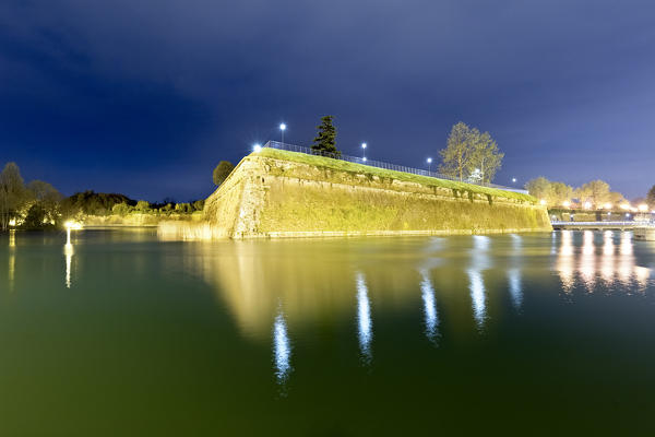 The walls of the Venetian fortress in Peschiera del Garda are reflected in Lake Garda. The fortification is today a UNESCO World Heritage Site. Verona province, Veneto, Italy. Europe.