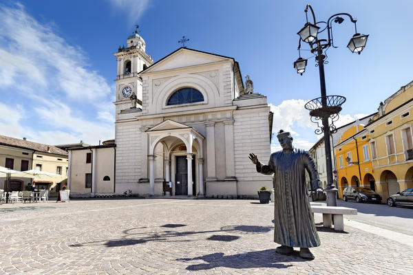 Brescello: the Santa Maria Nascente church and the statue of Don Camillo. The village is famous for the films of Don Camillo and Peppone inspired by the books of Giovannino Guareschi. Reggio Emilia province, Emilia Romagna, Italy, Europe.