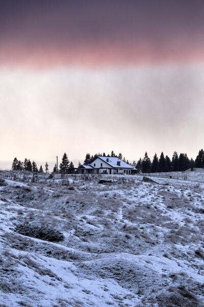 Malga Cima Verle and the snow-covered meadows of Vezzena. Levico Terme, Alpe Cimbra, Trentino, Italy.