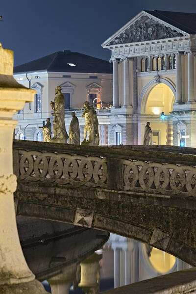 Bridge and sculptures of Prato della Valle. In the background the ex Foro Boario. Padua, Veneto, Italy.