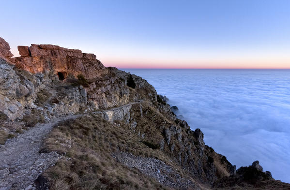 The Strada delle 52 Gallerie (Road of 52 tunnels) at dusk, Pasubio massif, Vicenza Province, Veneto, Italy, Europe.
During the First World War the Italian army dug this incredible track along the cliffs of the mountain.