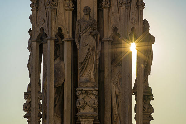 Milan, Lombardy, Italy, Europe. Detail of a statue on one of the spiers of Milano Cathedral