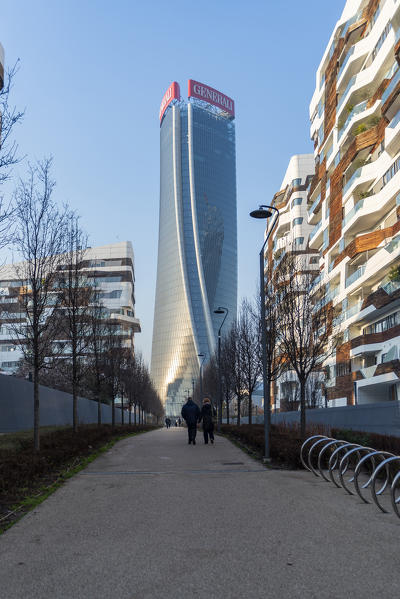 Milano, Lombardy, Italy, Europe. Couple wlaking towards Hadid Tower and passing by Hadid houses in CityLife district