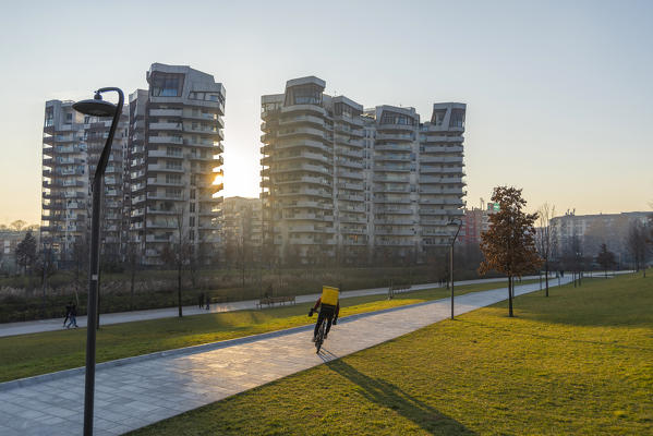 Milano, Lombardy, Italy, Europe. Rider passing by Daniel Libeskind's CityLife Residences