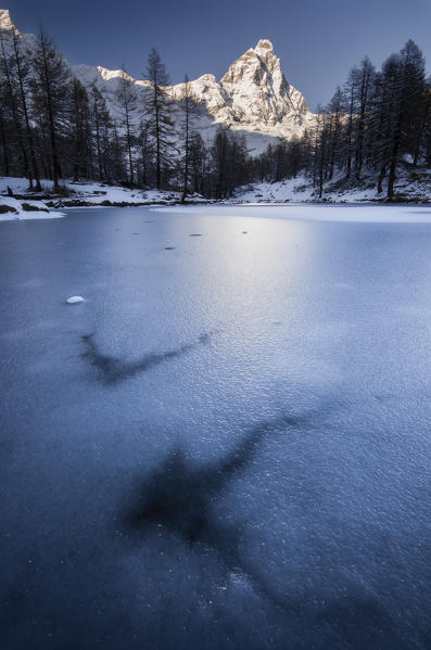 Iced blue lake in Breuil-Cervinia, Valtournenche, Aosta Valley, Italy