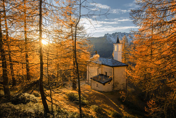 Notre-dame-de-guèrison in Cheneil with larches in foliage, Valtournenche, Aosta Valley, Italy