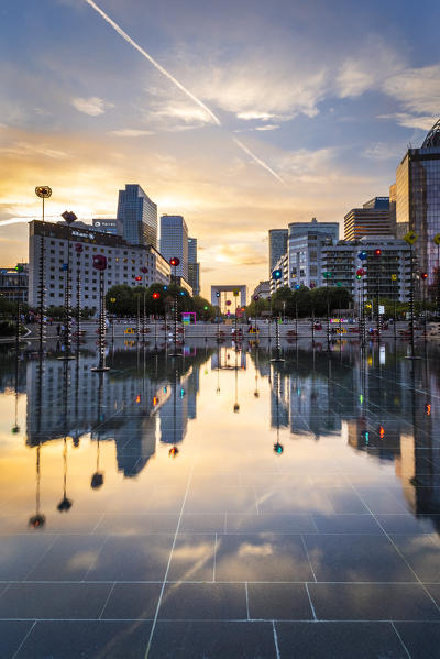 La Défense’s Skyscrapers and Arc de la Défense reflected in a fountain at sunset (Paris, Ile-de-France, France, Europe)