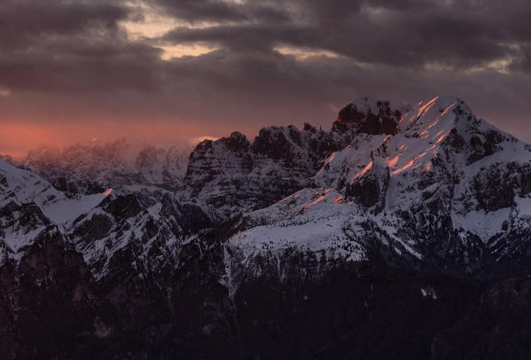Sunset on the top of Dolada Mount, in Alpago mountain range, Italy