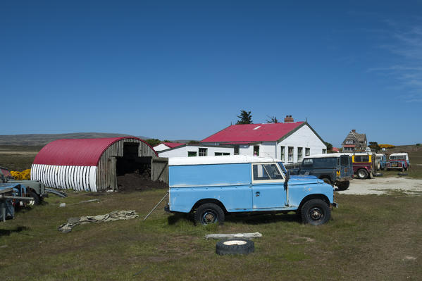 Land Rover cars in a  settlement near Cape Dolphin, Falkland Islands.