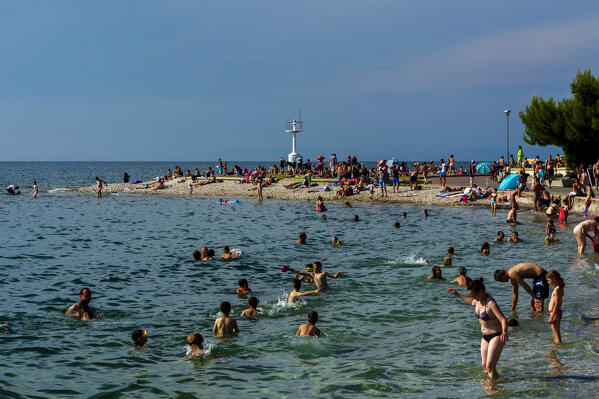 People on the beach of Isola, Slovenia.
