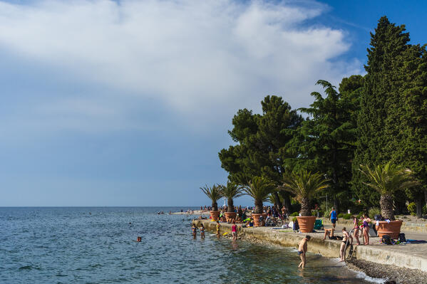 People on the beach of Isola, Slovenia.