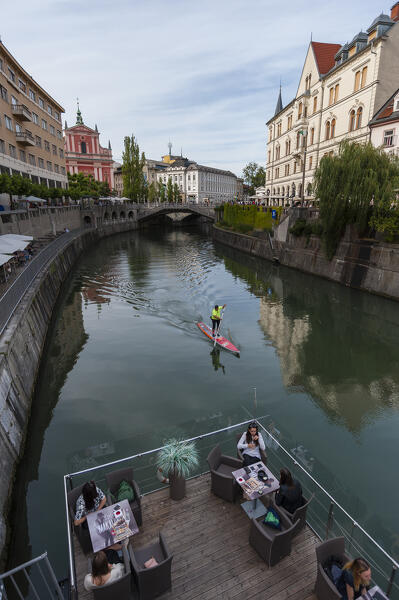 An outdoor cafe on the Ljubljanica River in the center of Ljubljana, Slovenia.