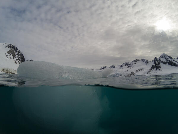 Over-under image of an iceberg, Fuglefjorden, Spitsbergen, Svalbard Islands, Norway.