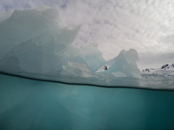 Over-under image of an iceberg, Fuglefjorden, Spitsbergen, Svalbard Islands, Norway.