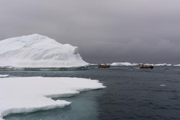 Ecotourist in zodiacs exploring  Brasvellbreen. south of Austfonna ice cap, Nordaustlandet, Svalbard, Norway.