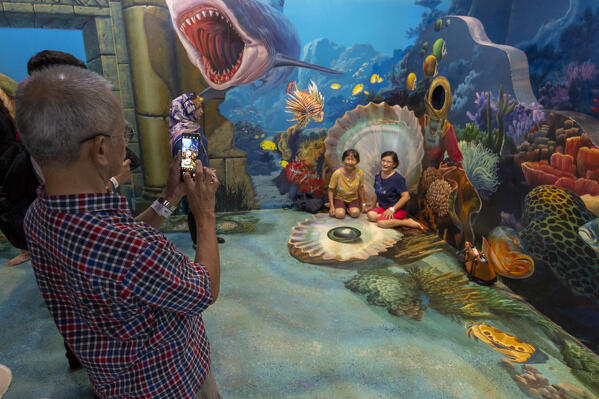 Tourist taking pictures at Art in Paradise 3D museum,  Langkawi, Malaysia.