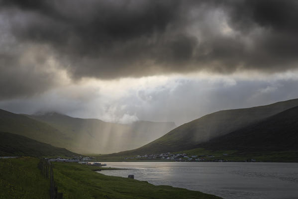 Europe, Denmark, Faroe Islands: the sun passes through the stormy clouds