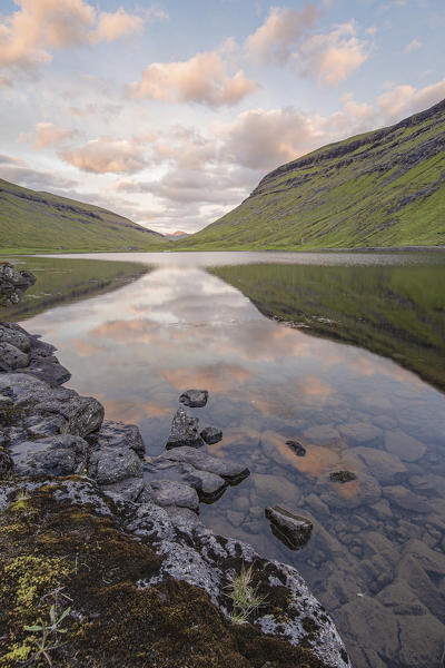 Europe, Denmark, Faroe Islands, Streymoy, Saksun: clouds reflecting in the lake at sunset