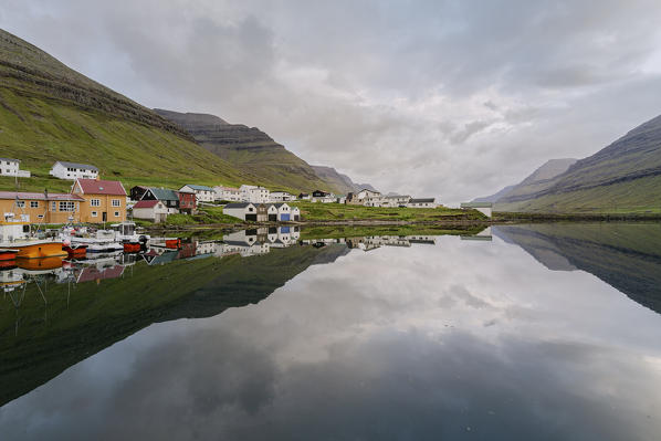 Europe, Denmark, Faroe Islands, Vidoy, Hvannasund: the town reflecting into the fjord