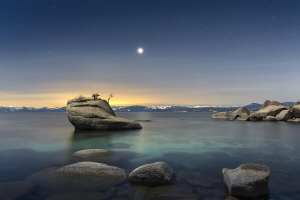 USA, Nevada, Lake Tahoe: moon rising over Bonsai Rock