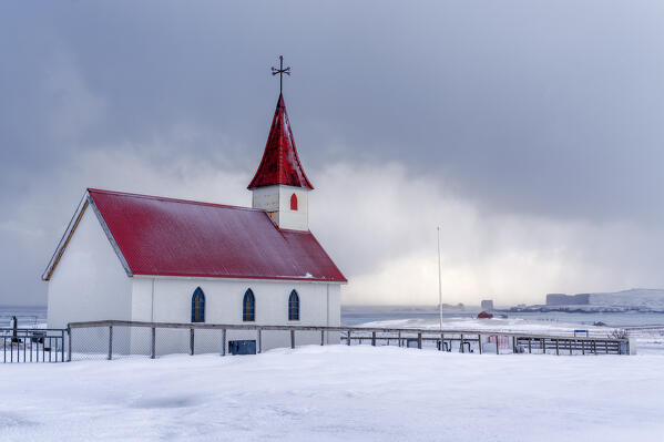 Europe, Iceland: the little church of Reynisfjara looking at the storm on the seashore