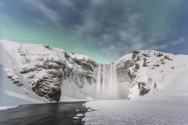 Europe, Iceland: the Aurora Borealis is coming over Skogafoss