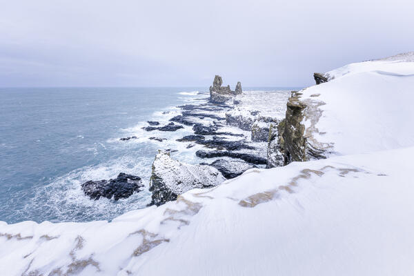 Europe, Iceland: Londrangar cliffs in a winter stormy day