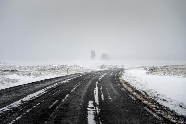 Europe, Iceland: Londrangar rock pillars rise from the mist at the end of the road