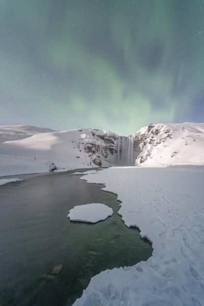 The famous Skogafoss under the Northern Lights, Iceland, Europe