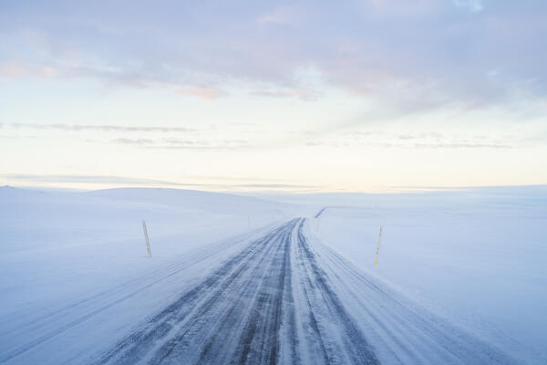 Europe, Northern Iceland: the dawn on a lonely snowcovered mountain road in the northern fjords region