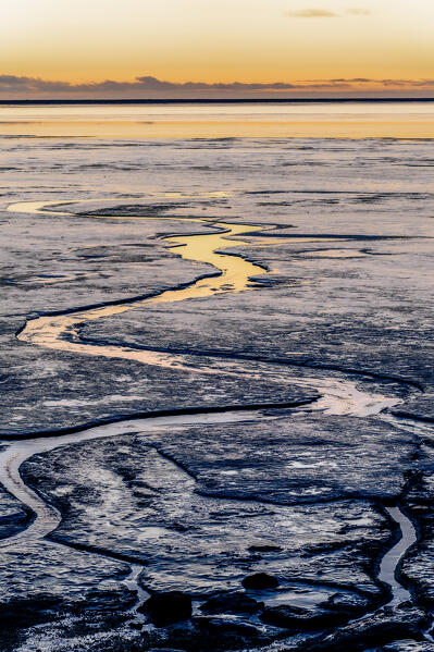 Europe, Southern Iceland: sunset reflecting in the ice on the road to Stokksnes, Vestrahorn, Hofn