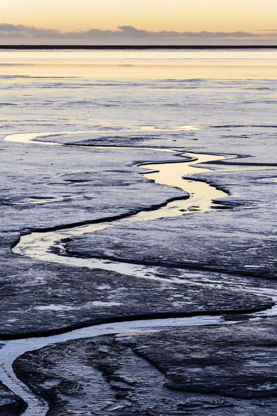 Europe, Southern Iceland: sunset reflecting in the ice on the road to Stokksnes, Vestrahorn, Hofn