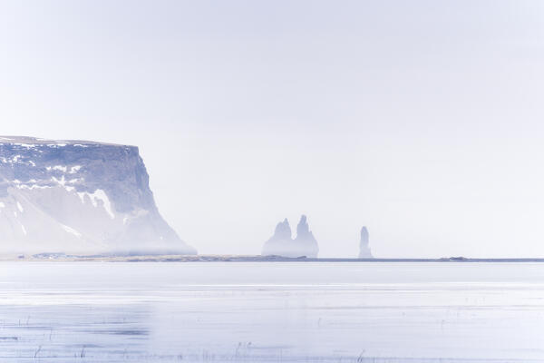 Europe, Southern Iceland: the iconic pillars over the iced sea of Reynisfjara black sand beach