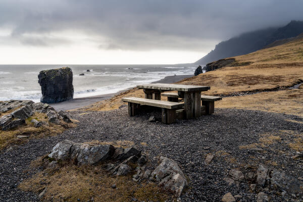 Table and benchs at the Stapavik beach at evening after the storm: Eastern Iceland, Europe 