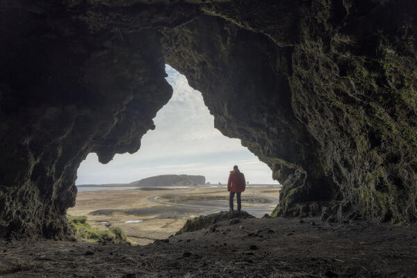 Standing on a cliffedge looking to the Dyrholaey promontoryand Reynisfjara Black Sand Beach: Southern Iceland, Europe 