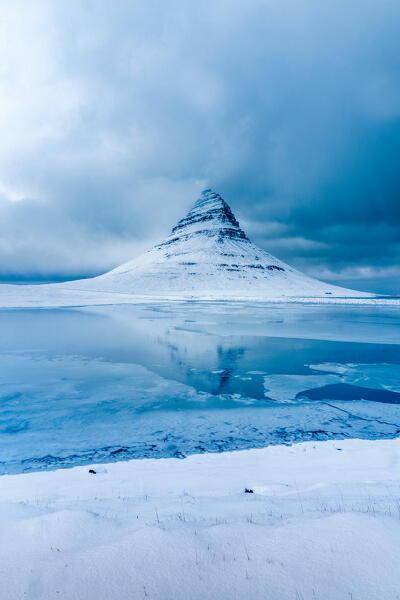 The iconic reflection of the Kirkjufell mountain: Snafellsnes Peninsula, Western Iceland, Europe