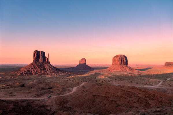 Epic sunset on the Mesas of the Monument Valley Navajo tribal park, the perfect postcard from the Far West; Arizona, United States of America