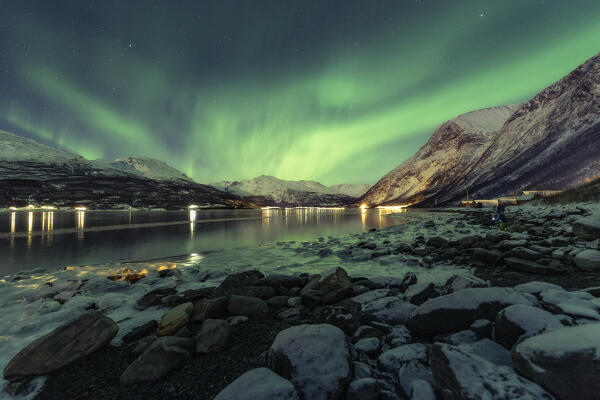 Classical view of Lofoten Islands, the northern lights reflecting into the fjord's water: Europe, Norway 