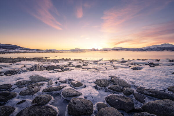 Sun rises on a fjord in the arctic landscape of Lofoten Islands: Europe, Norway 