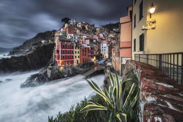 Cloudy evening over the village of Riomaggiore, National Park of Cinque Terre, municipality of Riomaggiore, La Spezia province, Liguria district, Italy, Europe
