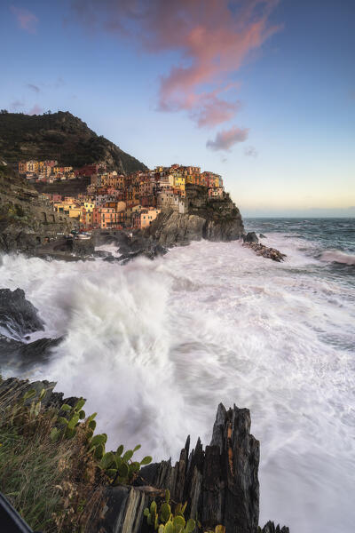 Storm at sunset on the cliff of the village of Manarola, Cinque Terre National Park, municipality of Riomaggiore, La Spezia province, Liguria district, Italy, Europe
