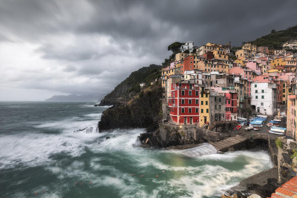 Cloudy evening over the village of Riomaggiore, National Park of Cinque Terre, municipality of Riomaggiore, La Spezia province, Liguria district, Italy, Europe
