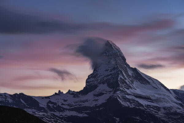 Sunset with a small cloud at the iconic Matterhorn, Switzerland north face, Zermatt, Switzerland