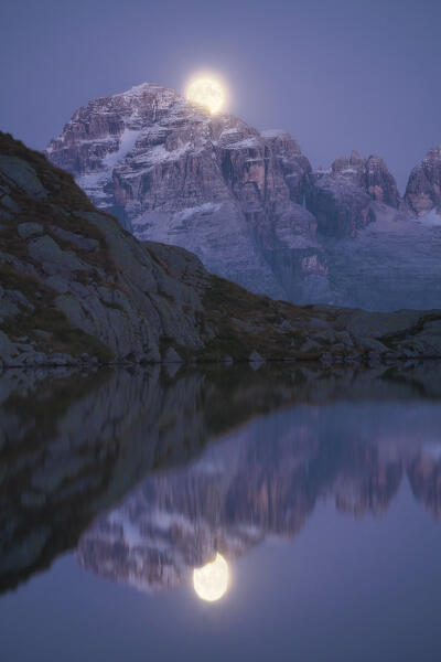 The nascent Moon on Cima Grostè Mountain and Black Lake of Cornisello, Dolomiti di Brenta Group, Unesco Heritage, Trento, Trentino Alto Adige, Italy