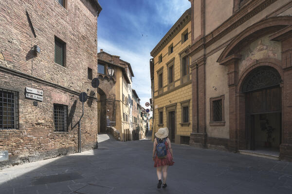 A young girl walking around the streets of Siena, Tuscany, Italy, Europe