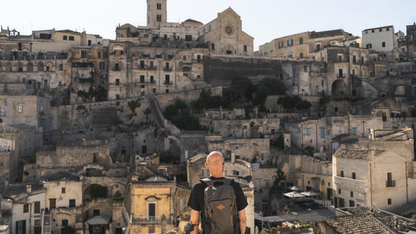 A young man is admiring the beautiful city of Matera. Matera, Basilicata, Italy, Europe