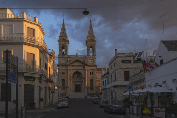 street view of Alberobello and the Basilica Saints Medici Cosma and Damiano. Alberobello, Bari province, Apulia, Italy, Europe