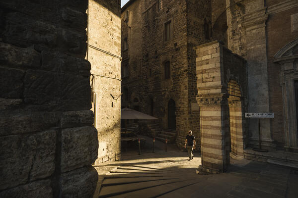 A young man is walking down the street. Perugia, Perugia Province, Umbria, Italy,Europe